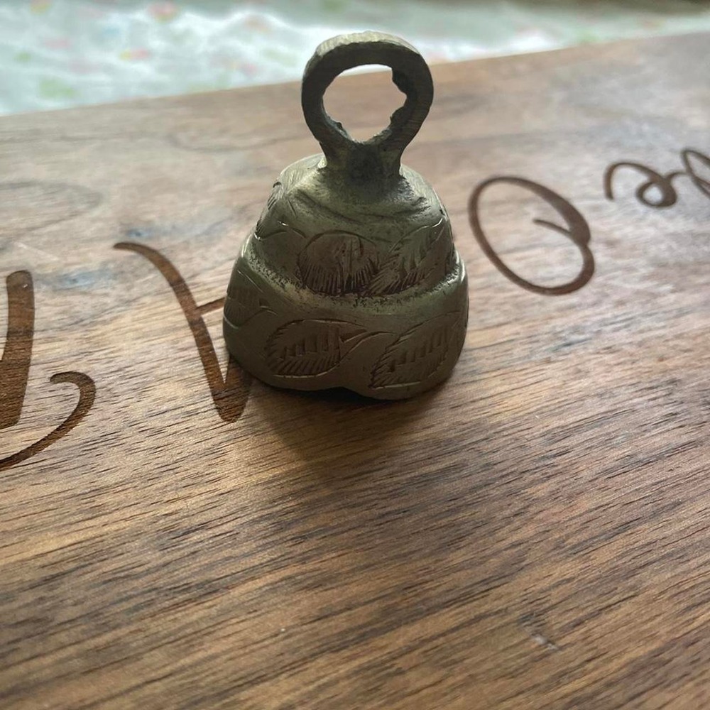 Brass metal bell with carved leaf designs